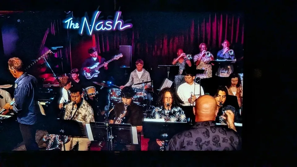 Jazz ensemble performing under The Nash neon sign