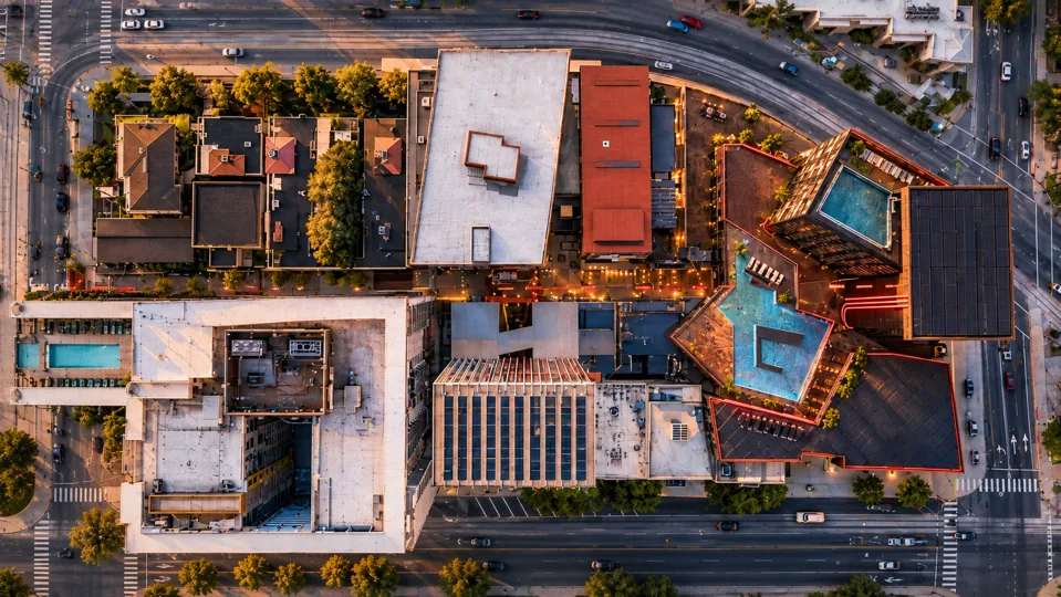 Wide overhead architectural visualization of the Fascination Street neighborhood at dusk