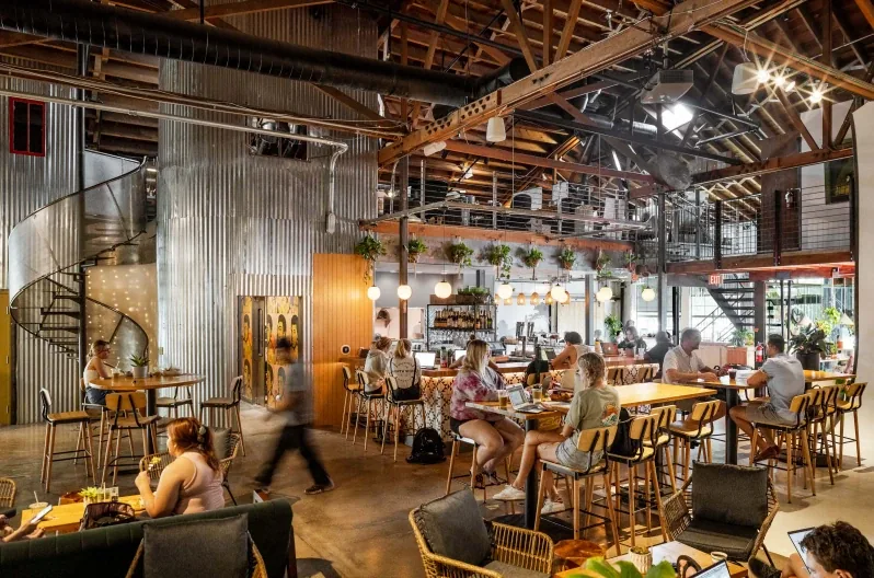 Guests gathering in monOrchid’s industrial interior